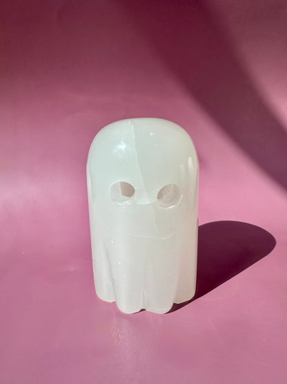 White ghost-shaped object on a pink background

